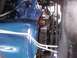 1978 Ford Bronco - Close-up view of an engine bay, showing a blue painted engine block, belts, and pulleys.