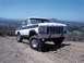 1978 Ford Bronco - This 1978 Ford Bronco is shown off-road with a clear blue sky and distant hills.