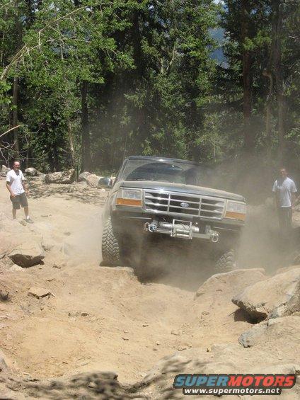 Gray 1995 Ford Bronco navigating a dusty, rocky trail