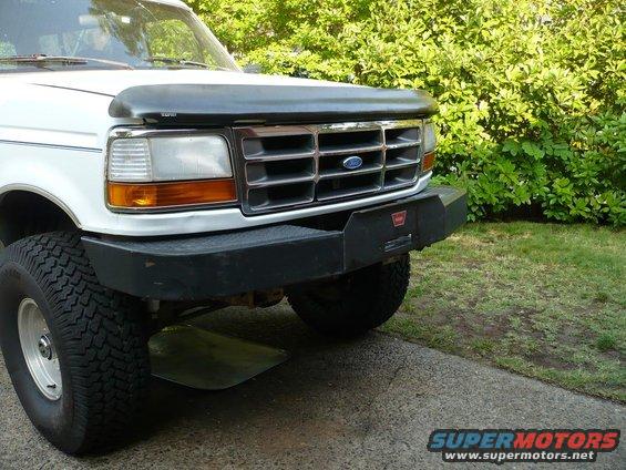 1992 Ford Bronco front end with chrome grille and aftermarket black bumper. Hood deflector is installed