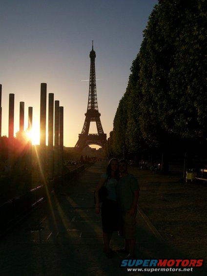 Couple in front of Eiffel Tower at sunset