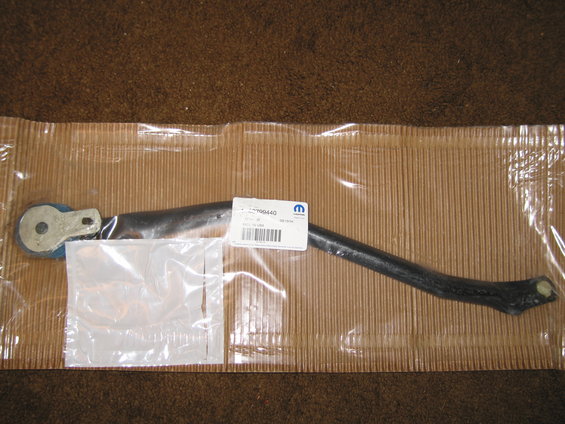 Black automotive part with a blue circular component, in plastic packaging with a Mopar label