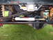 1982 Ford F-100 - Close-up view of a steering stabilizer mounted on a vehicle's suspension system.