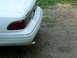 1997 Mercury Grand Marquis - The rear of a white 1997 Mercury Grand Marquis shows its chrome bumper trim and a visible exhaust tip.