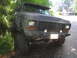 1979 Ford Bronco - This lifted Ford Bronco has a camouflage paint job and is parked off-road.