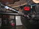 1979 Ford Bronco - Close-up view of the driveshaft and suspension components, including a "High Angle Driveline" sticker and a red shock absorber mount.