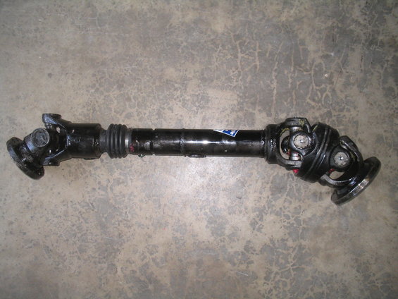 black driveshaft with u-joints and a rubber boot