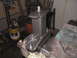 1979 Ford Bronco - A custom metal bracket assembly, likely for a vehicle modification, is secured in a vise for work.