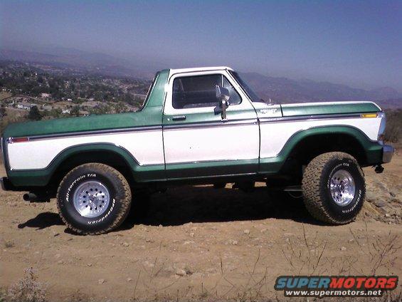 Side view of a 1978 Ford Bronco, two-tone green and white, lifted on off-road tires