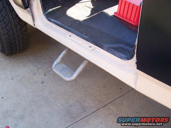 Close-up of a vehicle's interior step and tire