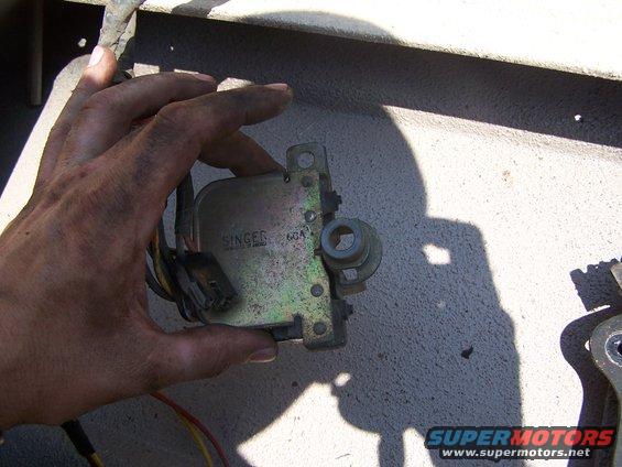 Singer 60A part held by hand