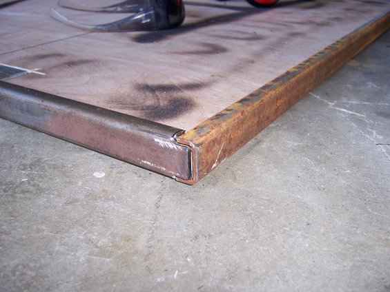 Metal frame on plywood surface with concrete floor