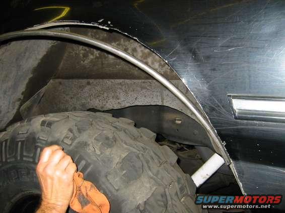 fittingsteeltube.jpg Shaping 1/2 steel tube around opening.  It fits between outer and inner sheet metal -- HUGE strength improvement and no biggie if the tire rubs on it (it won't, though!)