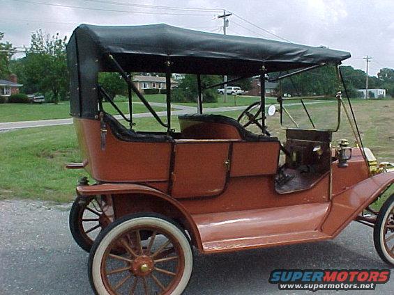 1912 Ford Model T with black soft top, seen from the front-right