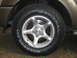 2004 Dodge Durango - Close-up of a wheel and tire on a tan SUV, showing the tire brand and tread pattern.