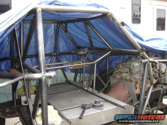 Custom buggy frame with blue tarp overhead, engine visible on right