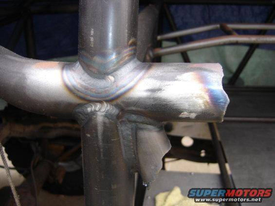 Close-up of welded metal tubing, likely part of a roll cage or custom frame