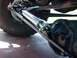 1982 Ford F-100 - This photo shows a steering assist cylinder, likely for off-road use, attached to the front axle and tie rod assembly.
