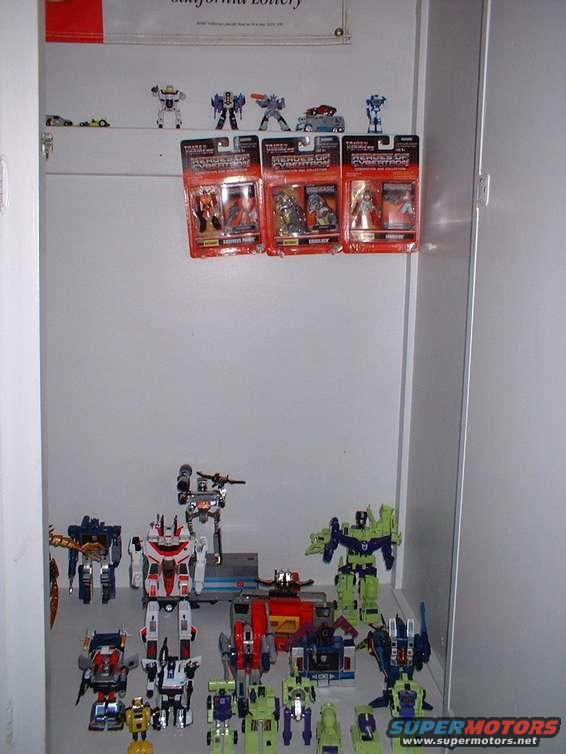 Shelf with boxed Transformers toys and assembled Transformers toys