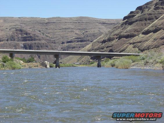 Bridge over a river with mountains in the background