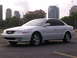 2003 Acura TL - White 2003 Acura TL sedan parked on asphalt with a city skyline behind it.