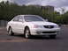 2003 Acura TL - A white 2003 Acura TL sedan is shown from the front-right angle in a parking lot.
