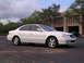 2003 Acura TL - A white 2003 Acura TL is parked in front of a modern building.