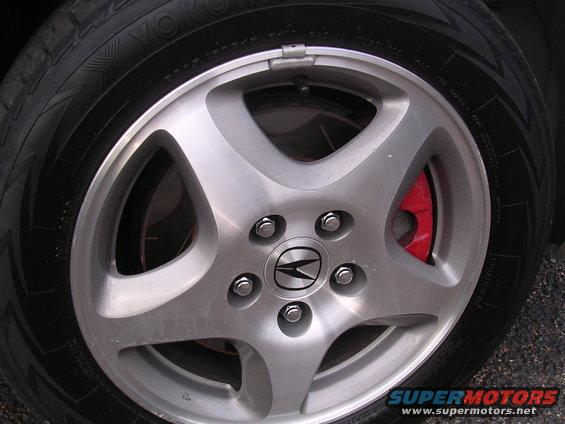 Close-up of a 2003 Acura TL wheel and red brake caliper