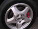 2003 Acura TL - Close-up of a 2003 Acura TL wheel, showing the alloy rim and red brake caliper.