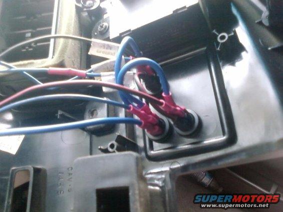 Close-up of blue and red wires connected to electrical terminals