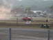 1984 Ford Bronco - Red lifted 1984 Ford Bronco participating in an event on a dirt track.