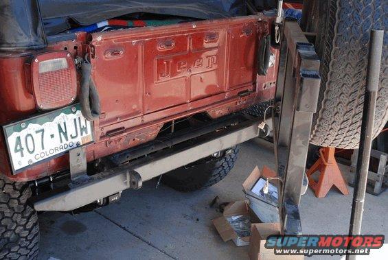 Rear of a red Jeep with a Colorado license plate and a spare tire mounted on a rack