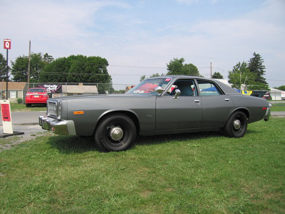 1977 Dodge Monaco sedan, gray exterior, black steel wheels, parked on grass