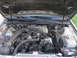 1995 Ford Thunderbird - The engine bay of a 1995 Ford Thunderbird is visible with the hood open.