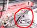 1998 Ford Taurus - This image shows a section of an engine bay, focusing on hoses and wiring, with a red circle highlighting specific components.