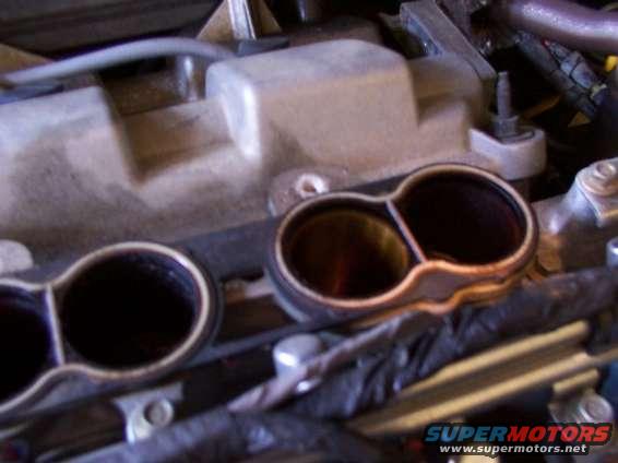 Close-up of a dual-port engine intake manifold with visible internal surfaces