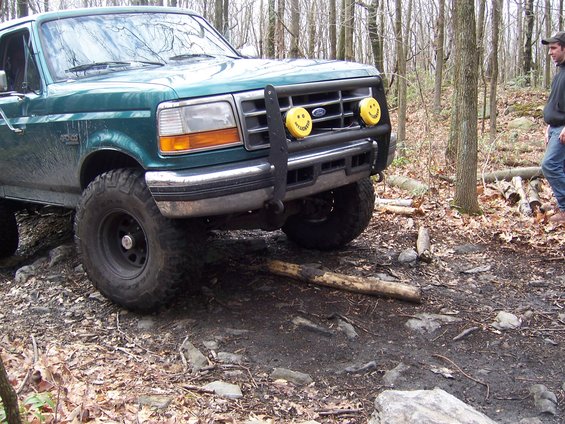 Green 1996 Ford Bronco with smiley face lights on bull bar