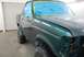 1996 Ford Bronco - A dark green Ford pickup truck is shown from the front quarter angle, possibly an older generation model.