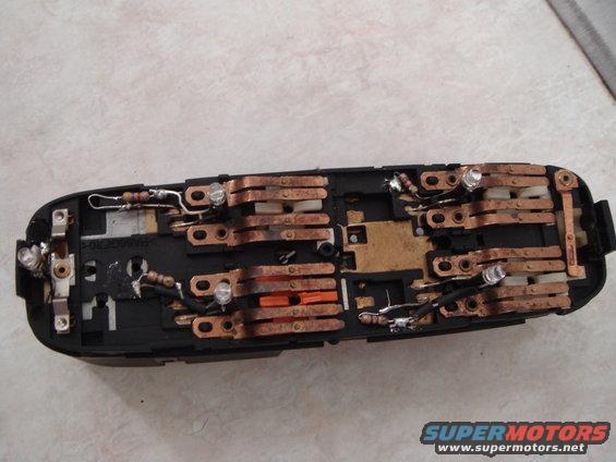 dsc02096.jpg The master switch.  The polarity on the window switch LEDs is the reverse of all the other switches.  Cut both LED s off near the top of the tower, then bend down the tab closest to the recess so you can solder the resistor down there.