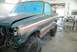 1996 Ford Bronco - A Ford Bronco is being prepped for a paint job in a workshop, with its hood open and windows covered.