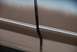 1996 Ford Bronco - A detail shot focuses on the gap between two body panels on a vehicle, accented by thin racing stripes.