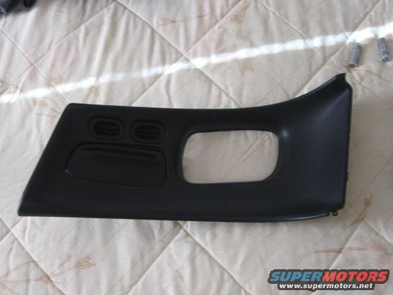 Black plastic interior trim piece with two air vents and a rectangular cutout
