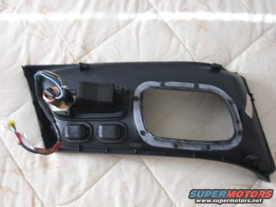 Car door panel with wiring and mounting points. Has a large cutout for a speaker or window mechanism