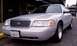 1998 Ford Crown Victoria - This silver 1998 Ford Crown Victoria is captured from a front three-quarter angle, its grille and California license plate.