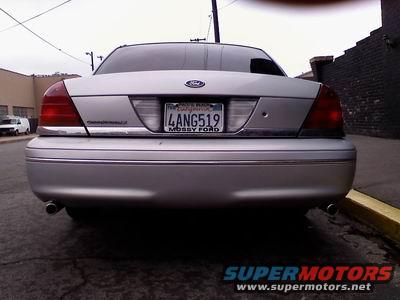 1998 Ford Crown Victoria rear view with license plate 4ANG519. Watermark "SUPERMOTORS" at bottom right