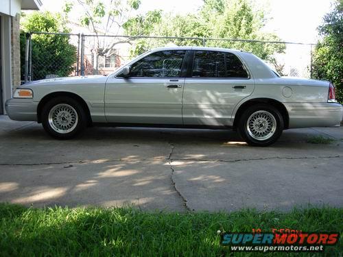 1998 Ford Crown Victoria parked on a concrete driveway, side view