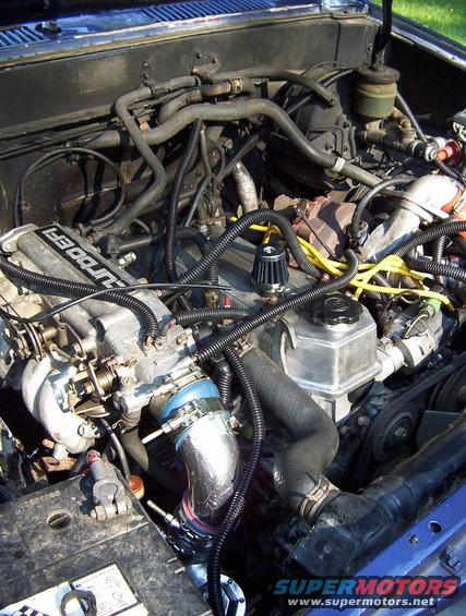 Engine bay with turbocharger and "TURBO EFI" text on intake manifold