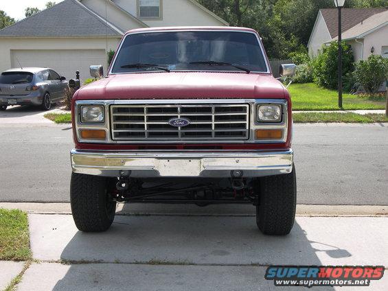 Front view of a red Ford pickup truck, possibly from the early 1980s