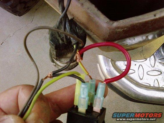 Wiring harness connected to a relay with red, yellow, and green wires