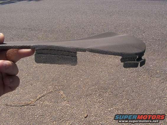 Carbon fiber trim piece held by a hand